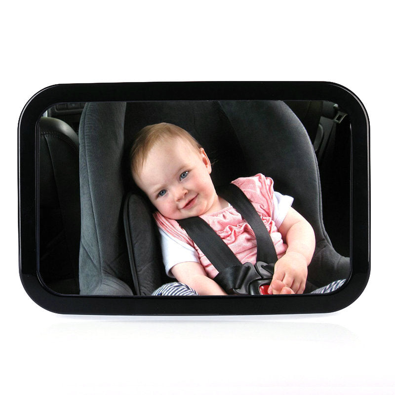 Baby in a car seat viewed through a black baby mirror