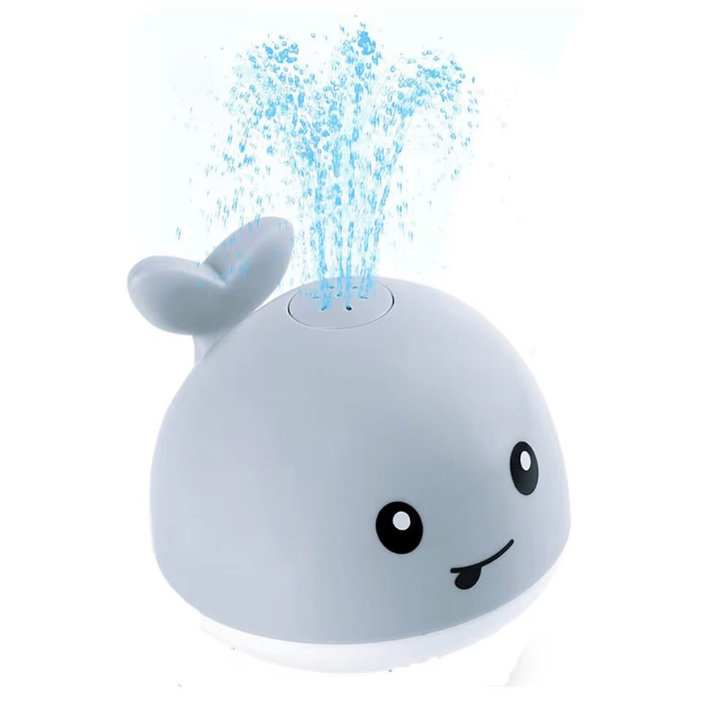 Whale-shaped night light with water spray feature on a white background