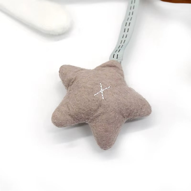 Star-shaped plush toy with a white cross on a white background