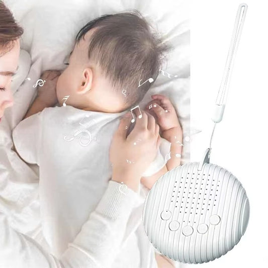 Baby sleeping next to a white noise machine with music notes around