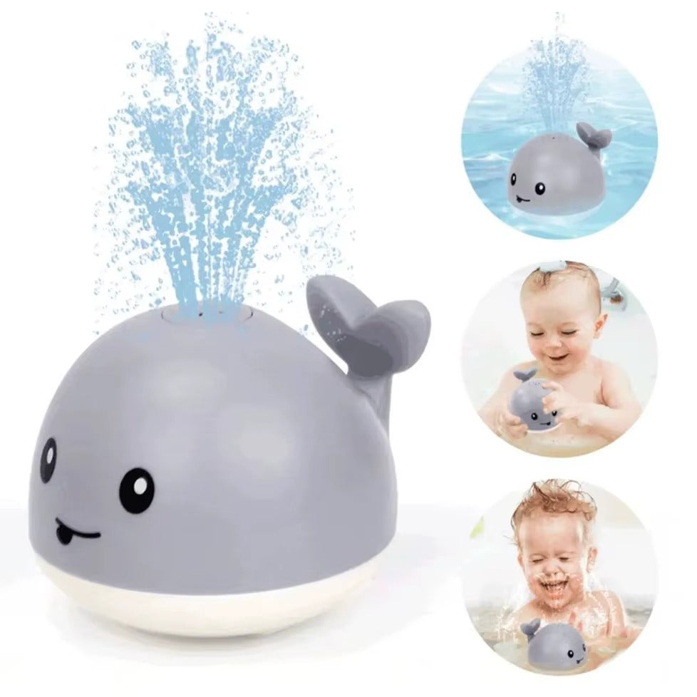 Gray whale-shaped bath toy with water sprayer, surrounded by images of a baby and the toy itself.